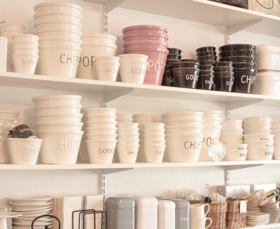 white black bowls organized on open shelves in business