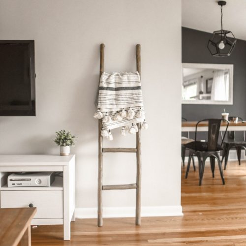 blanket ladder in modern home with wooden floors very similiar to Ramona Aline home style